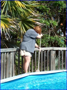 Jeanette sweeping by the pool