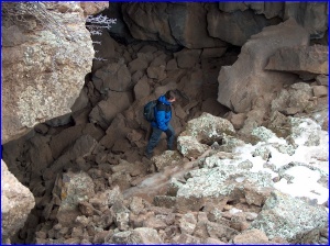 Sterling emerging from Junction Cave, a lava tube in El Malpais NM